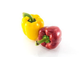 Red and yellow peppers solated on white