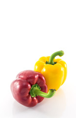 Red and yellow peppers solated on white