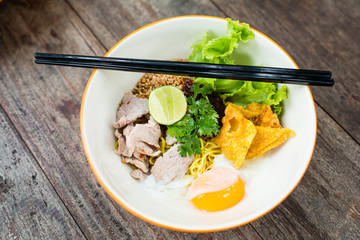 Pork noodle with Soft-boiled egg on wooden table