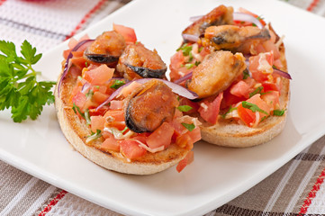 Bruschetta with mussels, cheese and tomatoes