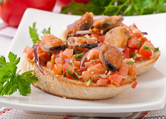 Bruschetta with mussels, cheese and tomatoes