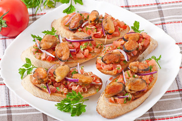 Bruschetta with mussels, cheese and tomatoes