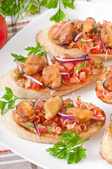 Bruschetta with mussels, cheese and tomatoes