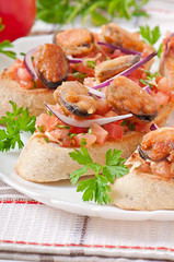 Bruschetta with mussels, cheese and tomatoes