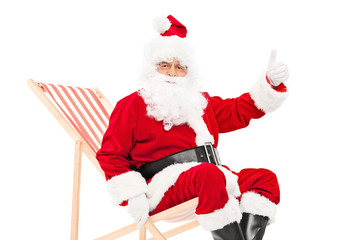 Santa giving a thumb up seated in a sun lounger