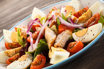 Boiled eggs with roast chicken fillet and vegetables