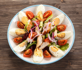Boiled eggs with roast chicken fillet and vegetables