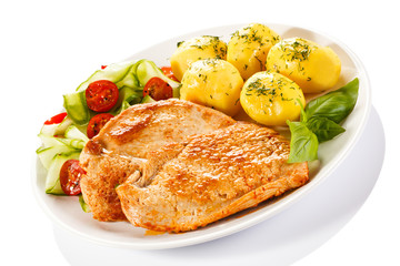 Fried pork chops, boiled potatoes and vegetable salad