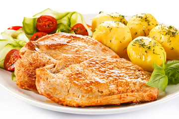 Fried pork chops, boiled potatoes and vegetable salad