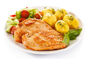 Fried pork chops, boiled potatoes and vegetable salad