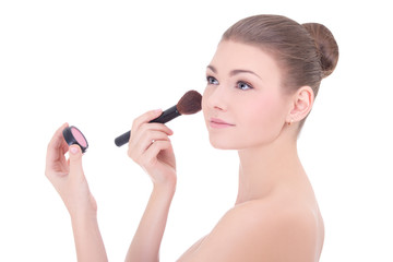 portrait of young beautiful woman with make up brush applying ro