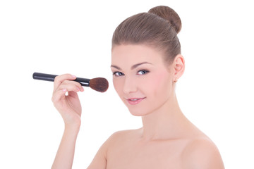 portrait of young beautiful woman applying rouge or powder with