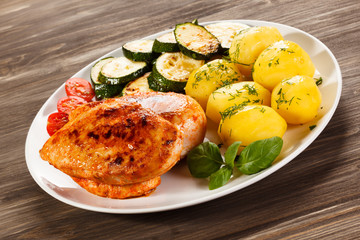Fried chicken fillet, boiled potatoes and vegetable salad