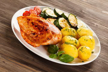 Fried chicken fillet, boiled potatoes and vegetable salad