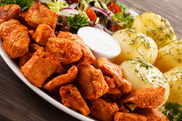 Fried chicken nuggets, French fries and vegetables