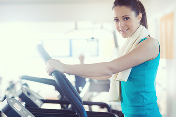 Fototapeta premium Attractive woman doing cardio exercise at gym