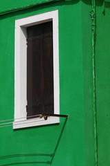 window on a green wall of the House  of Burano venice