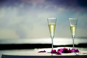 Two glass of white wine on the sky background