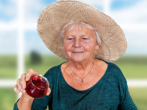 One Mature Woman With Straw Hat And Homemade Jam