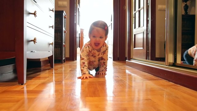 Happy baby girl at floor home