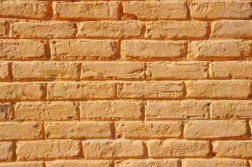 Orange painted brick wall closeup