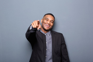 Young business man smiling and pointing finger