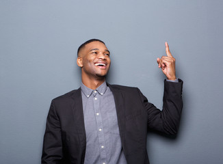 Happy black business man pointing finger