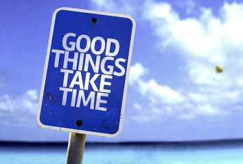 Good Things Take Time sign with a beach on background
