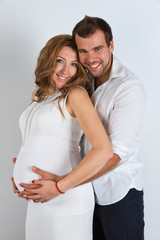 Fototapeta premium Happy Pregnant Couple on white background