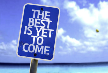 The Best Is Yet to Come sign with a beach on background