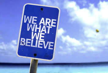 We Are What We Believe sign with a beach on background - obrazy, fototapety, plakaty
