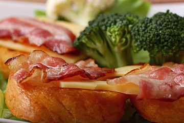 Serving breakfast toast with bacon and herbs