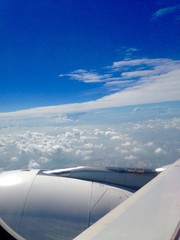 sky with clounds as seen through window of an aircraft 