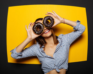 Girl holding a donut with chocolate icing