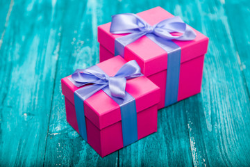 Pink gift boxes on blue wood