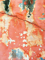 Cracked red wall with peeling paint