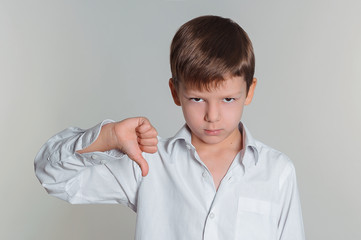 boy giving thumbs down sign