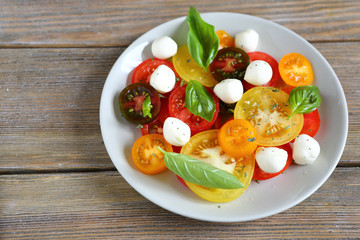 ripe tomatoes with basil and mozzarella