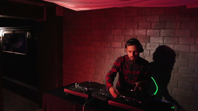 DJ using his mixer and  turntable