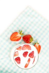 Tasty strawberries and glass of fresh milk as healthy background