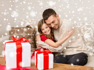Fototapeta na wymiar smiling father and girl with gift boxes hugging