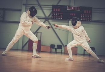 Little girl fencer and her trainer