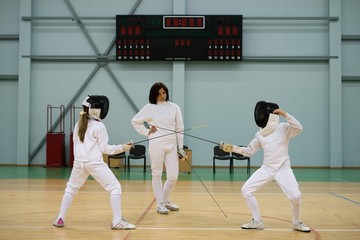 Children fencers and their  trainer