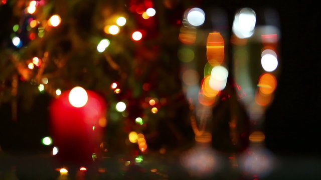 glasses with champagne and candle against christmas lights - rac