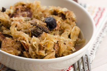 traditional polish sauerkraut (bigos) with mushrooms and plums
