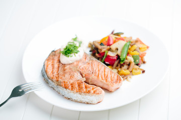 Grilled Salmon with Fresh vegetables on white background