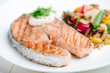 Grilled Salmon with Fresh vegetables on white background