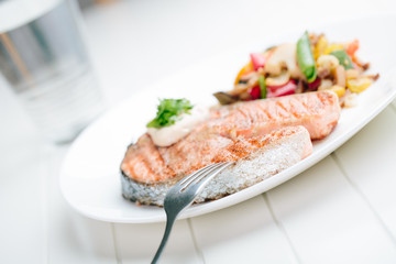 Grilled Salmon with Fresh vegetables on white background