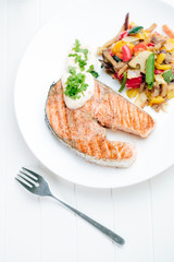Grilled Salmon with Fresh vegetables on white background