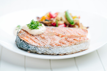 Grilled Salmon with Fresh vegetables on white background